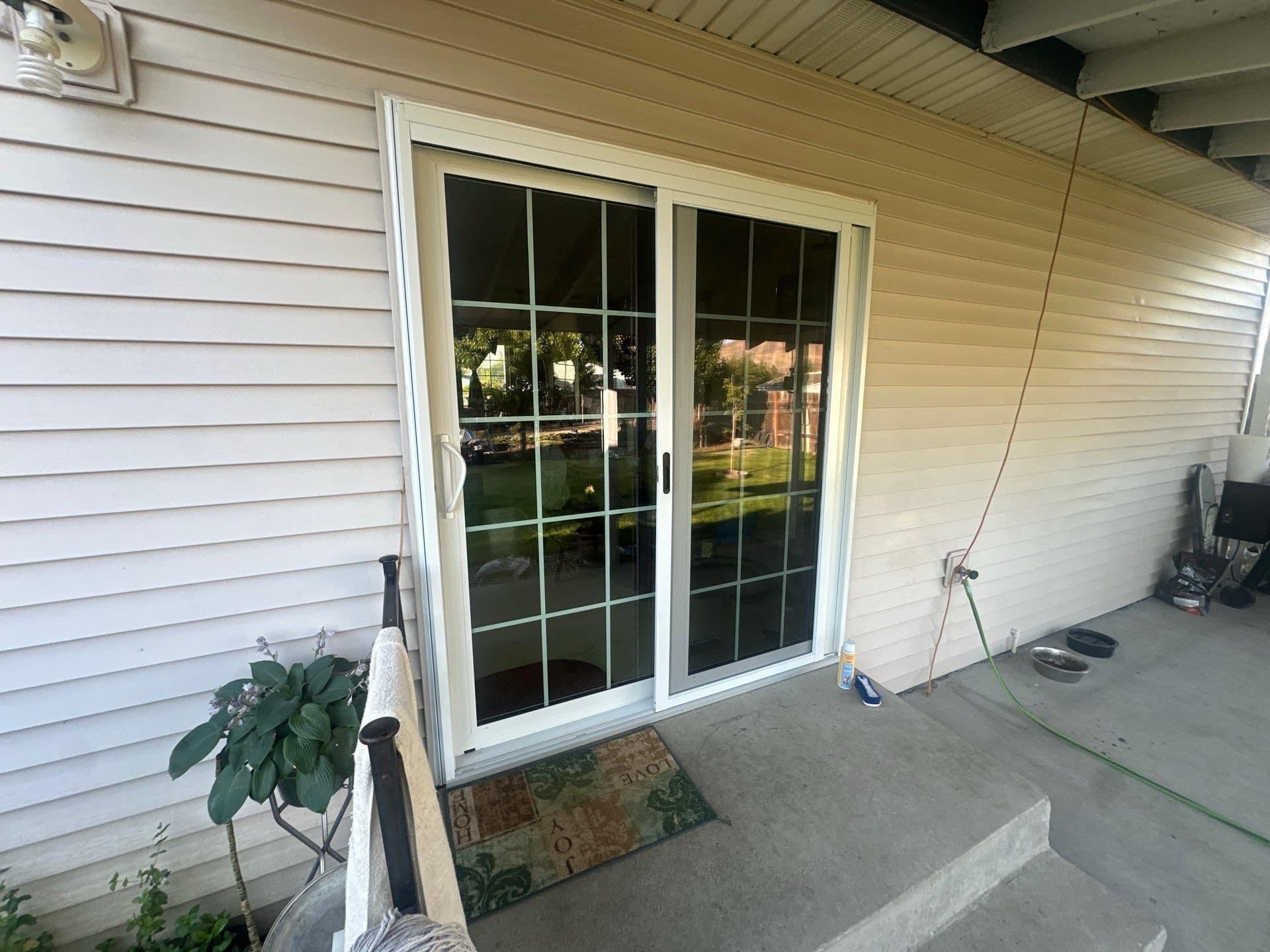 New white vinyl sliding patio door installed by BN Covered Exteriors